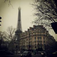 A building with the eiffel tower behind it.